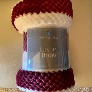 Maroon and white plush throw blanket.